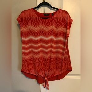 Large women’s red-orange colored and white blouse with tie bottom. Half sleeved.